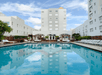 Outdoor heated swimming pool and hot tub at Marseilles Beachfront Hotel, FL.