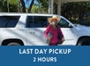 A woman in a big hat smiling in front of a white SUV and a box saying "Last Day Pickup 2 Hours" with Maui Pickup in Maui, Hawaii, USA.