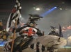 A knight is dressed in red, white, and black, and carries a flag.