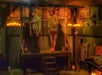 Two mannequins in tattered clothing stand on a platform in a dimly lit, medieval-themed room decorated with candles, skulls, and ancient-style tapestries.