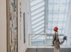 A woman in a red hat and long coat admiring some art on the wall on the Meet the Met: Metropolitan Museum of Art Tour in New York City, New York, USA.