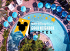 Aerial view of a hotel pool with blue umbrellas and lounge chairs, overlaid with the Walt Disney World Good Neighbor Hotel logo.