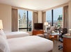 2 Double beds, city view, work desk, flat-screen TV, chair at Millennium Hotel, NY.
