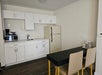 Kitchenette with a refrigerator, microwave, dining area, and a coffee maker.