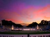 The National World War II Memorial in Washington, D.C. at sunset, with fountains and colorful sky in the background.