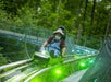 A man in a hat and overalls smiles on the Moonshine Mountain Coaster in Gatlinburg, TN, USA