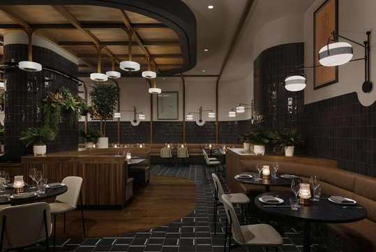 A modern restaurant interior with dark tile walls, wooden accents, and round tables set for dining. Pendant lights hang from the ceiling, and potted plants add greenery to the space.