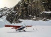 The plane at the glacier landing with the mountain peaks in the distance in Talkeetna, Alaska.