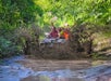 A family is covered in mud on their vehicle during the Mucky Duck Adventure