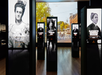 Exhibit displays with images and text about historical figures, including Emily Warren Roebling and Elizabeth Jennings Graham, are shown in a modern museum space with a city street photo in the background.