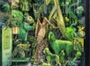 A store window display features a mannequin in a gold dress surrounded by green animal figures and various green props themed around "The Wizard of Oz.