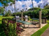 Outdoor BBQ area equipped with two grillers and long tables.