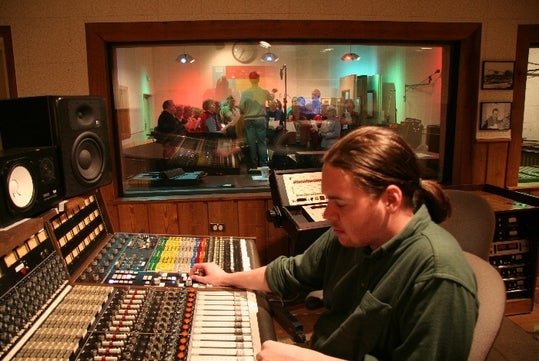 A group singing at the recording studio
