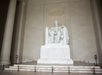 The marble statue of Abraham Lincoln seated at the Lincoln Memorial in Washington, D.C., with inscriptions visible behind the statue.