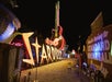 Neon signs, including a large "STARDUST" sign and a giant guitar for the Hard Rock Cafe, are illuminated at night in an outdoor display.