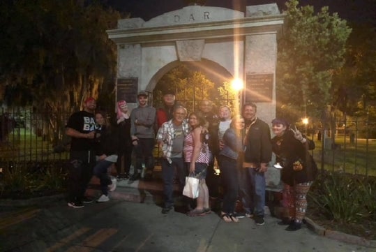 Tour group standing in front of an archway on the Night Terror Tour, Savannah Georgia.
