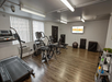 Fitness center with treadmill, elliptical trainer, and other gym equipment.