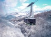 The Ober Mountain Tram gliding over a snow-covered Smoky Mountain landscape, offering stunning views of the valley and frosted trees below.