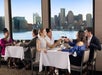 A group of people sitting at a table with wine glasses.