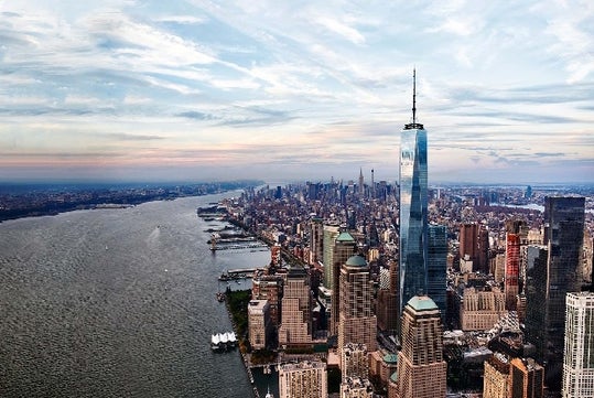 Aerial view of New York City with the One World Observatory to the left and the Hudson river to the left.