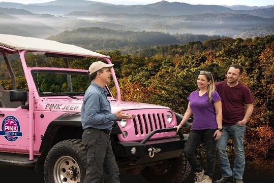 the tour guide talking with a couple of guess on the Foothills Parkway - Pink Jeep Tours in Pigeon Forge, Tennessee
