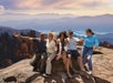 The tour group taking photos next to a cliff with Pink Jeep Tours in Pigeon Forge, Tennessee