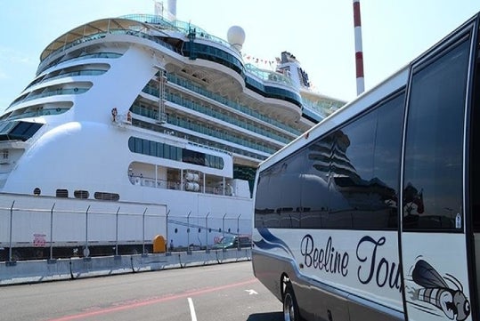 A large white cruise ship is docked at a port next to a tour bus labeled "Beeline Tours.