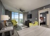 Suite with a bedroom, a living area, a dining area, and a private balcony.