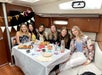 A group of girls celebrating a birthday on the Private Sailboat Charter to the Statue of Liberty and NYC.
