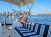 A woman lounging on deck of a Private Sailboat Charter to the Statue of Liberty and NYC.