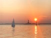 Suset views with the Statue of Liberty in the background on a Private Sailboat Charter to the Statue of Liberty and NYC.