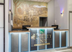 Quality Inn hotel reception area featuring a mural with people and a dog.