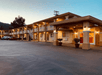 Exterior of the Quality Inn Ukiah with the outdoor lights on at sunset.