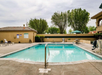 Outdoor pool with sun loungers.