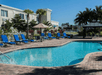 Outdoor pool with sun loungers at Quality Inn & Suites Near Fairgrounds & Ybor City.