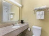 Guest bathroom with towels, mirror, and sink.