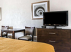 Convenient guest room setup with a table and TV.