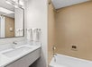 A relaxing bath experience with a tub, sink, and fresh towels for your comfort.