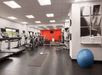 Fitness room with treadmills, and other cardio equipment and weights.