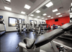Fitness room with treadmills, and other cardio equipment and weights.