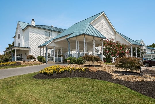 A large white building with a blue roof.