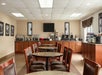 Breakfast dining area with a waffle station, buffet set up, assorted cereals and more.