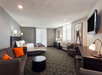 A spacious retreat with a king bed, cozy seating area, and a plush sofa for ultimate comfort.