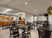 Breakfast area with a variety of breakfast items, seating area, juice machine and more.