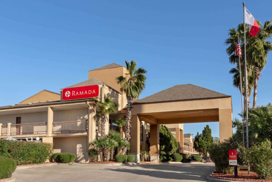 Beautifully landscaped entrance to the hotel with the hotel sign.