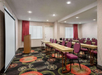 Meeting facility with projector and classroom-type setup.