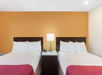 2 Double beds inside a guest room.