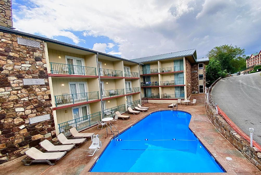 The outdoor pool offers a tranquil setting for swimming or lounging under the open sky.