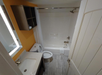 A well-appointed bathroom with a tub, toilet, and sink designed for convenience and relaxation.