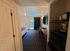 A well-equipped room featuring a king bed, desk, microwave, and TV, ideal for work or relaxation.